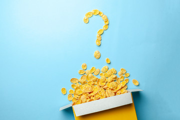 Poster - Scattered cornflakes out of the box in the shape of a question mark. Dry cereal breakfast