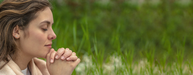 Christian worship and praise. A young woman is praying in the morning.