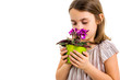© _jure - Sad young little girl holding flower pot mourning family loss.
