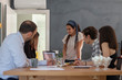 © Hakan Kızıltan - Smiling business woman standing in front of the table during presentation. Young woman standing in office and looking at a co worker and smiling