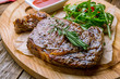 juicy Ribeye steak on wooden background