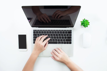 Poster - The top view of human hands, printed on a laptop computer on a modern desk in the office.