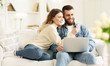 Surfing Internet. Young Couple Relaxing With Laptop