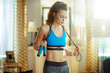 © Alliance - woman with a jump rope and heart rate monitor catching breath