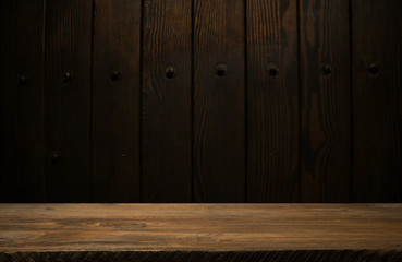 Selected focus empty brown wooden table and wall texture or old black brick wall blur background image. for your photomontage or product display