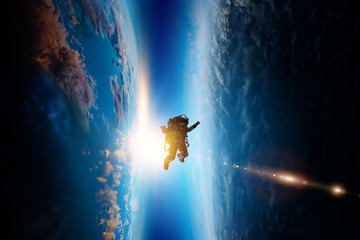 Wall Mural - spaceman and planet, human in space concept