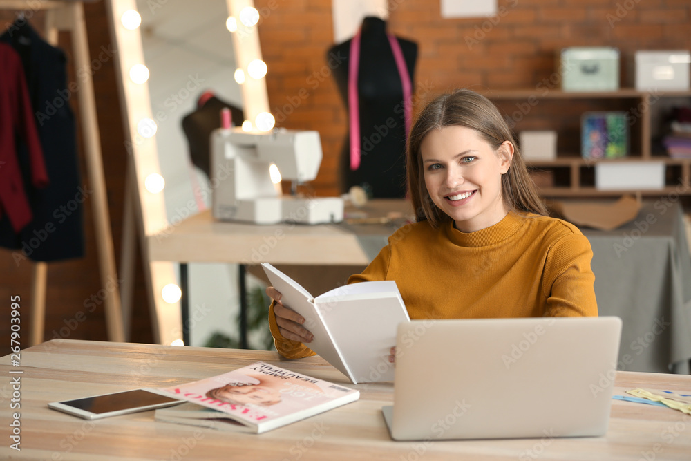 Beautiful female business owner working in atelier