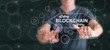 © thodonal - Man touching a blockchain concept