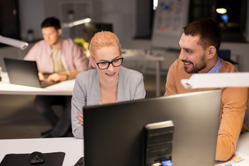 Canvas Print - business, deadline and technology concept - coworkers with computer working late at night office