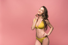 Pretty Young Woman In Yellow Swimsuit Isolated On Pink