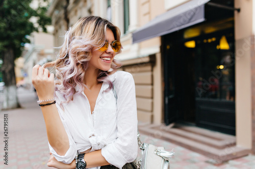 Pretty Girl Wearing Sunglasses And Bracelets Playing With
