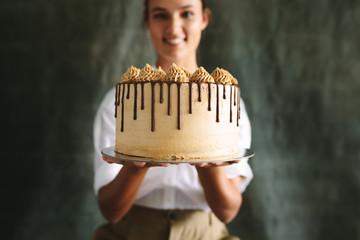 Female baker with a delicious cake