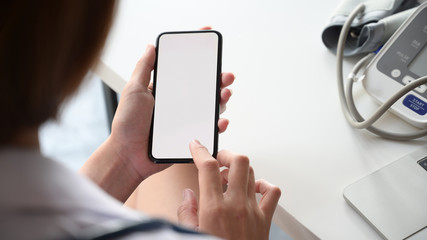 Smartphone with Blank screen in the hand of female doctor