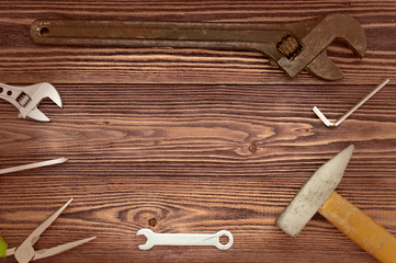 hammer and wrench on the wooden background with vignette