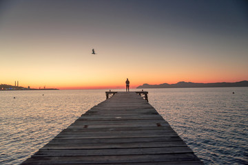  Woman standing alone on the pier