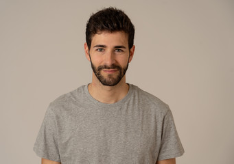 Natural portrait of young attractive man in his 20s looking and posing with neutral face expression