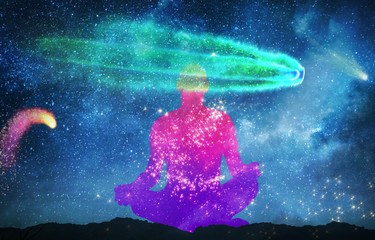 Wall Mural - silhouette of man practicing meditation outdoors in night under starry sky