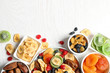 © New Africa - Bowls of different dried fruits on wooden background, top view with space for text. Healthy lifestyle