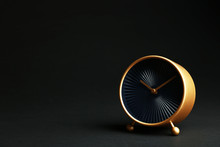 Golden Alarm Clock On Black Background. Space For Text