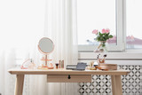 Fototapeta Boho - Dressing table with different makeup products and accessories in room interior