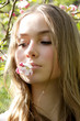 © Iveta - Portrait of young woman with flower in mouth