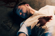 © LIGHTFIELD STUDIOS - dead man with blood on t-shirt on floor at crime scene