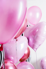 Set of balloons in the form of a heart and round pink and striped on light background with copy space.