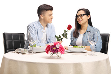 Poster - Boyfriend giving a red rose to a girlfriend at a restaurant