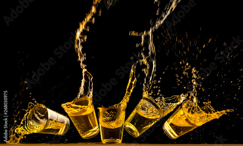 Pinturas sobre lienzo  Five golden tequila shots dropping on bar