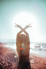 Selective Focus Photo Of Woman Raising Peace Sign Hand Gesture Standing On Shoreline