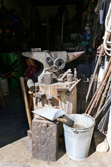 Antique anvil and various old tools, Material and accessories in grandfather's blacksmith's workshop