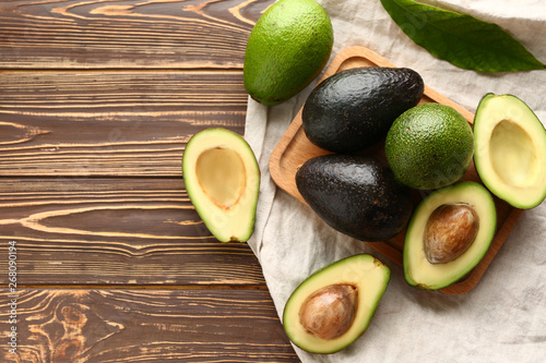 Fotografía Board with fresh avocado on wooden background