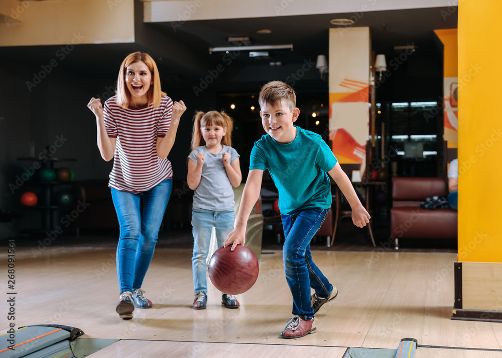 Family playing bowling in club