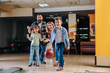 © Pixel-Shot - Family playing bowling in club
