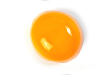 Raw egg yolk on a white background. Close-up. View from above. Protein