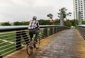 Man Biking To Work to Downtown Houston Over City Bridge