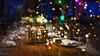 Blurred background of people sitting at restaurant, bar or night club with colorful lights bokeh.