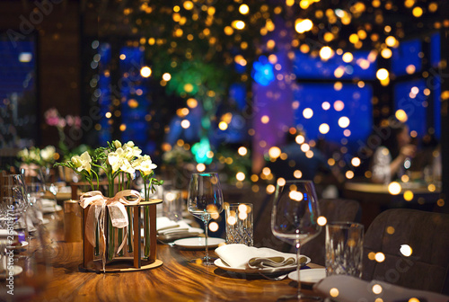 Fotomural Blurred background of people sitting at restaurant, bar or night club with colorful lights bokeh
