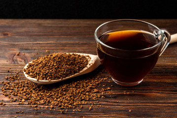 Wall Mural - Granulated coffee on dark wooden background.