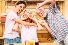 Senior Couple Grandparents With Teenager Nephew Having Fun At Breakfast. Craziness And Laughs. Wood On Background And On Table.Three People Enjoying Life. Food And Drink