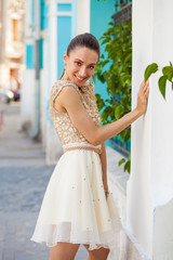 Poster - Portrait close up of young beautiful brunette woman in a beige dress