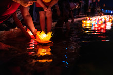 Floating Colored Lanterns And Garlands On River At Night On Vesak Day For Celebrating Buddha's Birthday In Eastern Culture, That Made From Paper And Candle