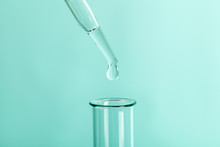 Drop The Pipette Into The Test Tube. The Study Of Biological Material. Laboratory Research. Green Background.
