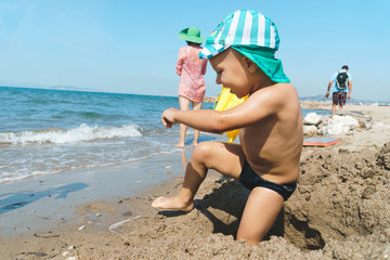 Canvas Print - boy playing in sand