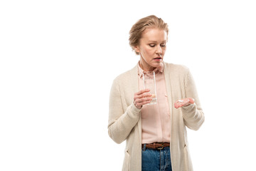 Wall Mural - middle aged woman with glass of water and pills Isolated On White with copy space