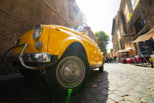 An Old Retro Yellow Car Standing On Italian Street