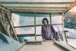 © zhukovvvlad - A woman works in a carpentry workshop.