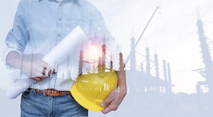 Double exposure of Engineer with safety helmet with construction industry background