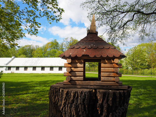 Wooden Carved Birdhouse On A Tree Stump A Feeder For Birds In The