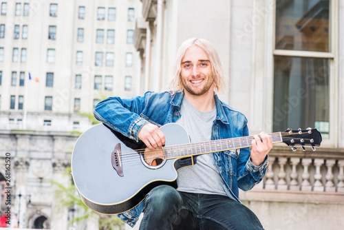 Happy Musician Playing Guitar Outdoor In New York City Young